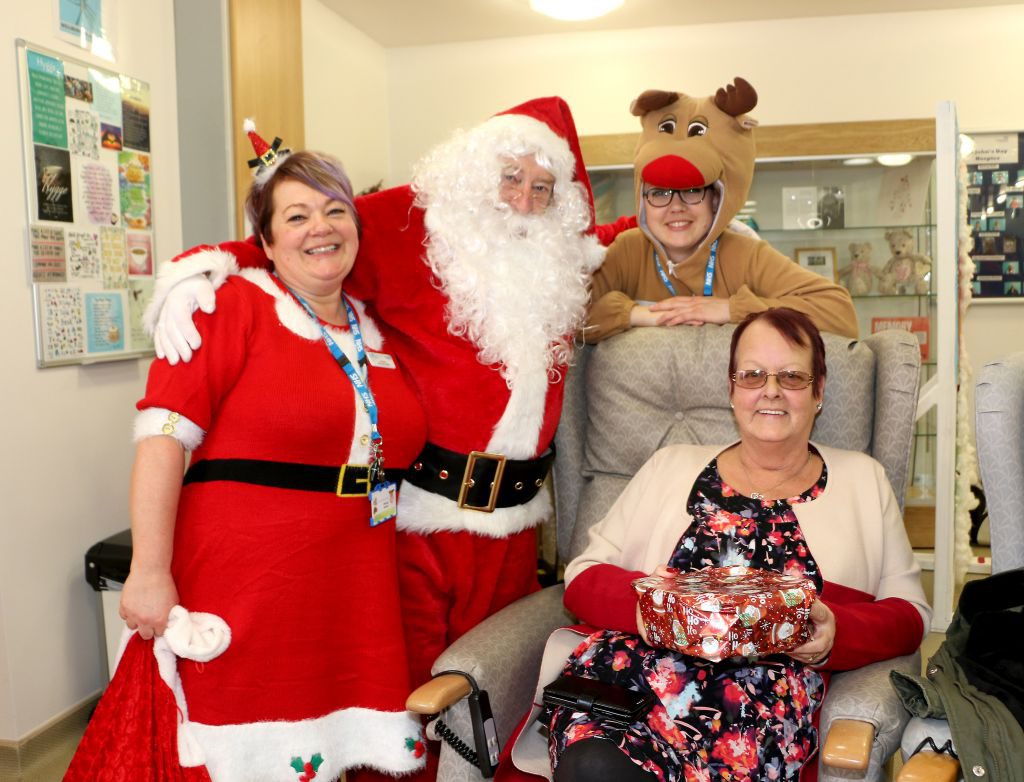 Hospice Sister Joanne Brooks is pictured with Father Christmas, Rudolf and hospice visitor Jane Birchall, who attended the event with her sister Ann.