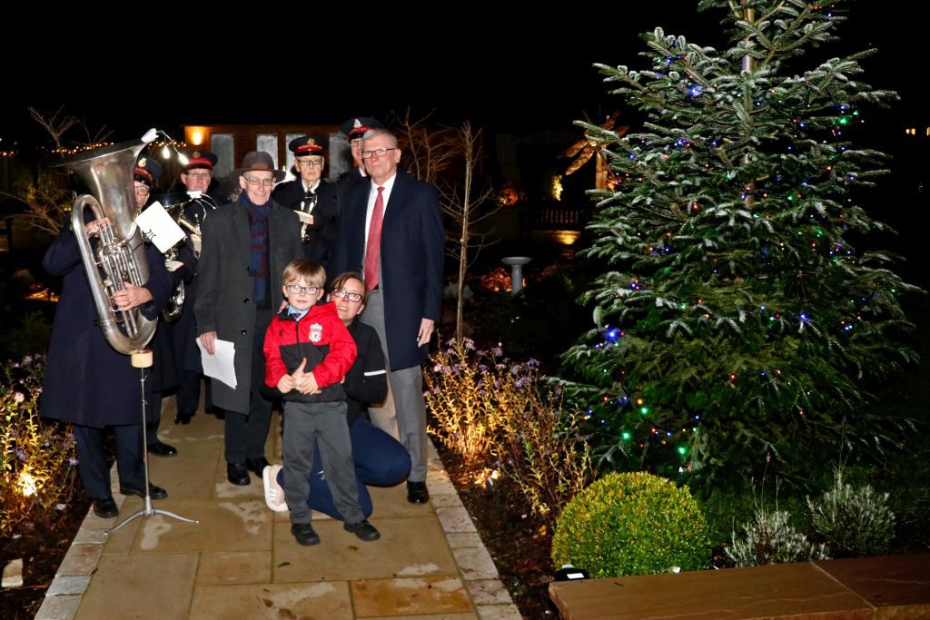 Harry Smith is pictured with mum Laura, Chairman Lawson Pater, Father Andrew Graydon and the Salvation Army band.