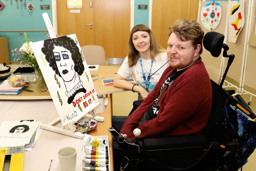 Philip Hood is pictured with his painting and Hospice Art Therapist Rachel Horne. 