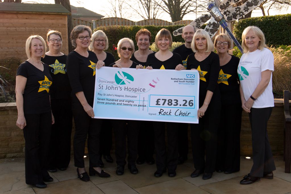 Pictured are members of Rock Choir with Lindsey Richards of the Hospice (far right).