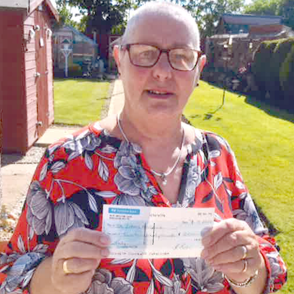 Jill with the cheque she handed over to the hospice