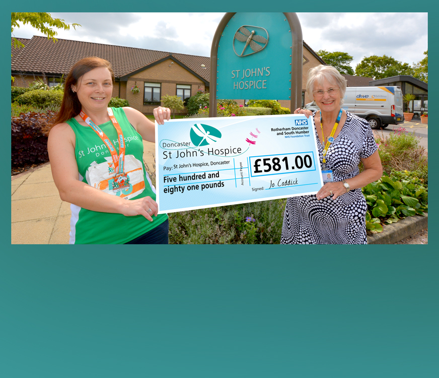 Jo pictured handing over her cheque to Maureen