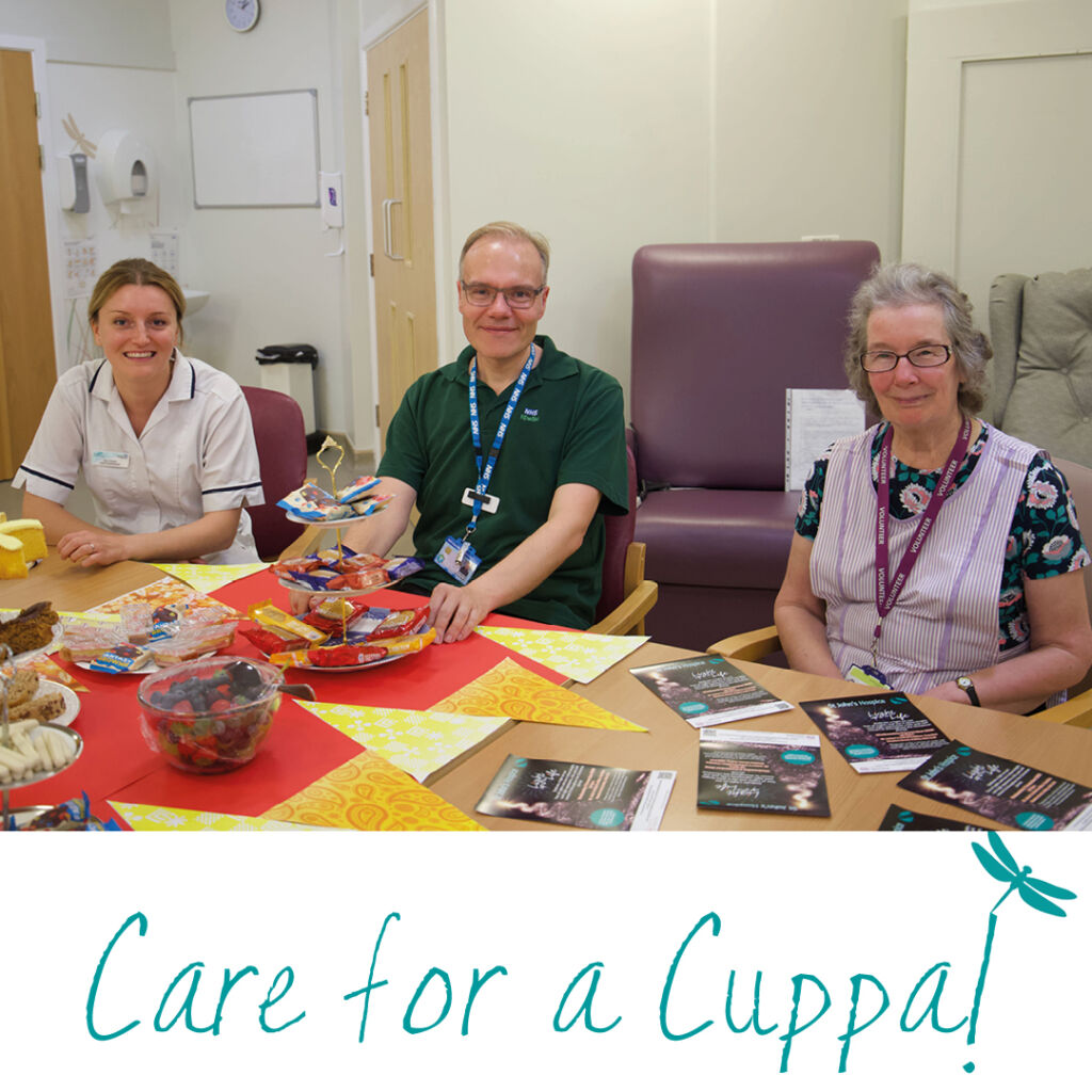 three members of the hospice team are pictured with a cake stand